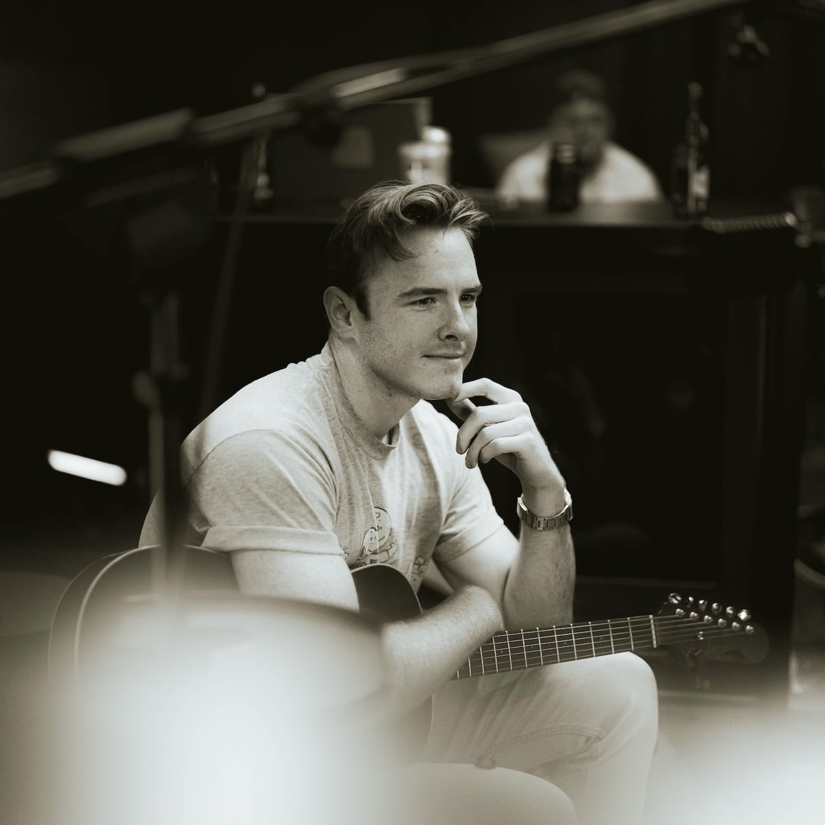 dylan kidd in the studio with a guitar